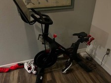 Black peloton bike with shoes